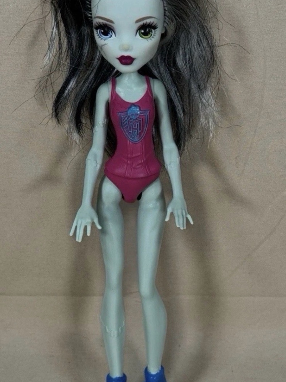 monster high doll with pink swimsuit and blue shoes
